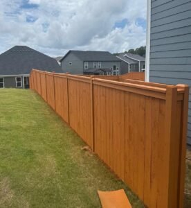 wood privacy cap and trim fence with solid cedar stain in Braselton