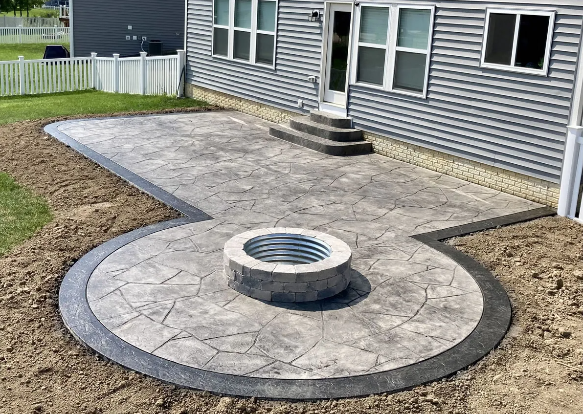 image showing custom stamped concrete patio with built in firepit in Dacula, GA